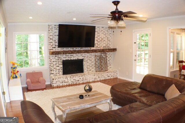1310 Larkview Dr SW, Lilburn, GA 30047 - living room with ceiling fan, wood finished floors, ornamental molding, recessed lighting, and a fireplace