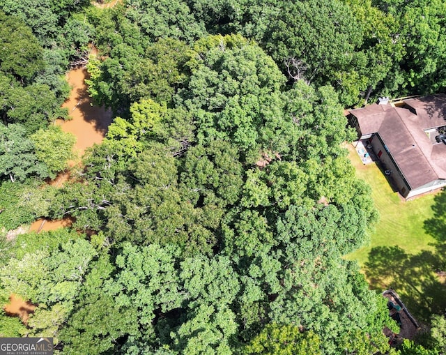 1310 Larkview Dr SW, Lilburn, GA 30047 - aerial view of property and surrounding area featuring a heavily wooded area