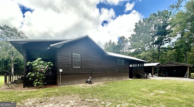 226 Cherokee Rd, Glenwood, GA 30428 - view of side of property featuring a lawn and a carport