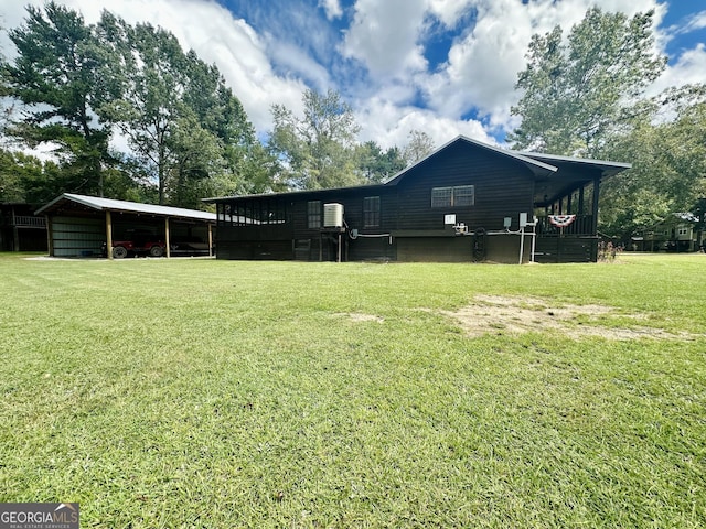 226 Cherokee Rd, Glenwood, GA 30428 - rear view of house featuring a lawn and a carport