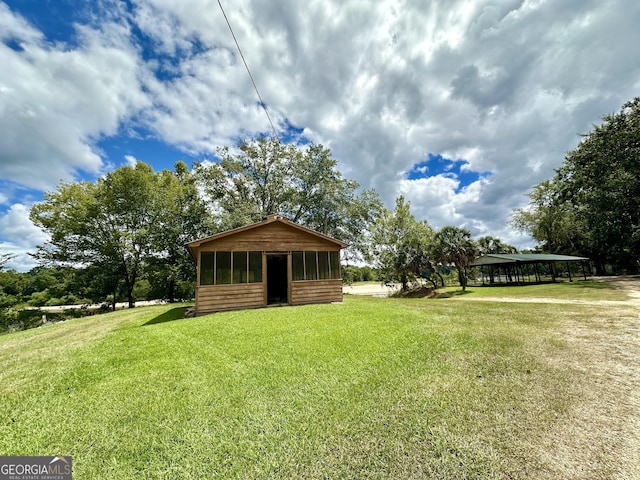 226 Cherokee Rd, Glenwood, GA 30428 - view of grassy yard featuring a sunroom