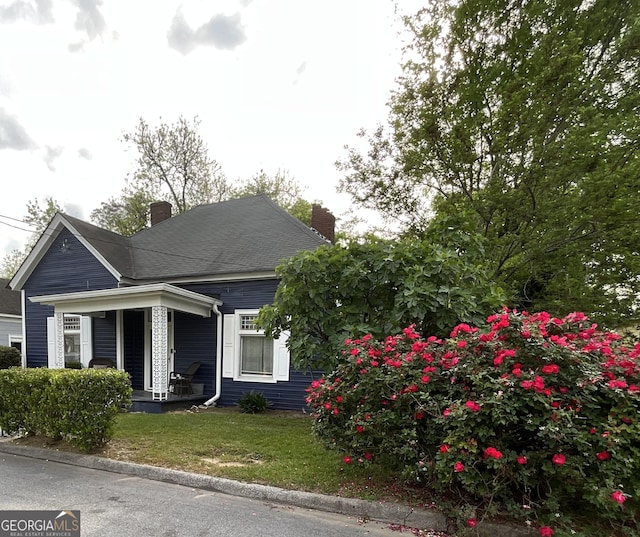 1012 Institute St NW, Conyers, GA 30012 - view of front of home featuring covered porch, a chimney, and a front yard