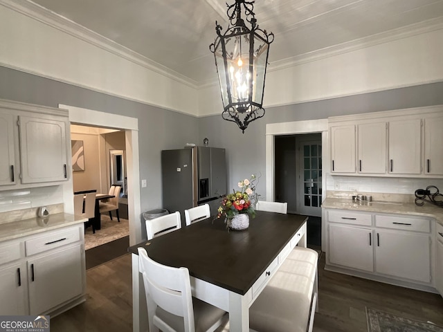 1012 Institute St NW, Conyers, GA 30012 - dining area featuring a chandelier, dark wood finished floors, and ornamental molding