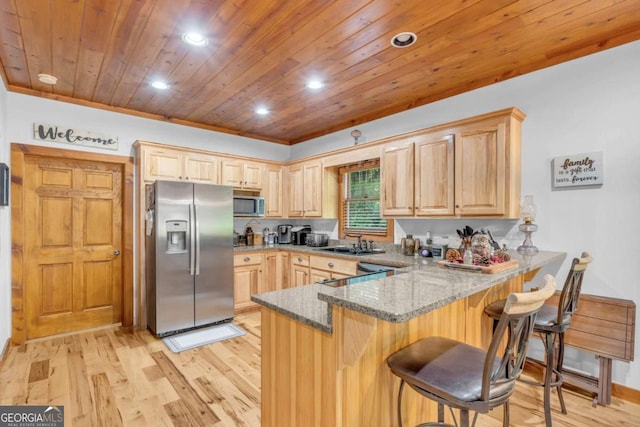 2357 Haven Heights Rd, Hiawassee, GA 30546 - kitchen with appliances with stainless steel finishes, light brown cabinetry, stone counters, a peninsula, and recessed lighting