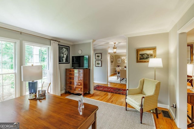 1060 Woodhollow Ln, Athens, GA 30606 - living room featuring crown molding, wood finished floors, and a chandelier