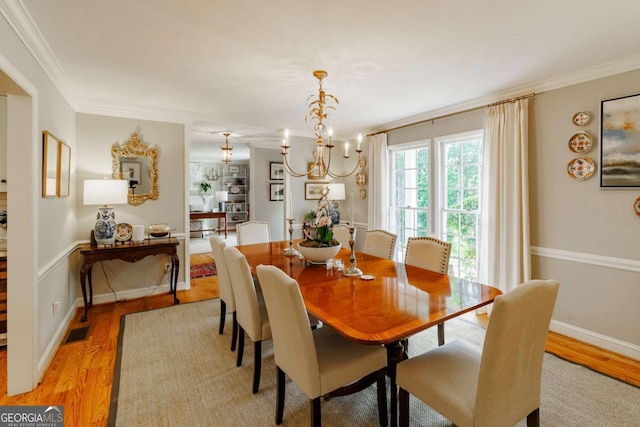 1060 Woodhollow Ln, Athens, GA 30606 - dining room with ornamental molding, light wood-type flooring, and a chandelier