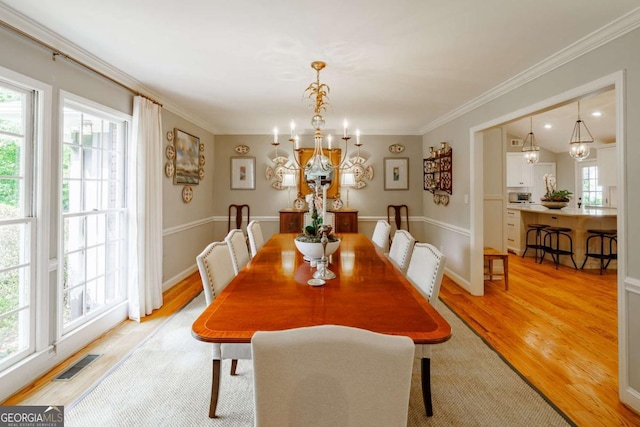 1060 Woodhollow Ln, Athens, GA 30606 - dining space featuring a chandelier, light wood-style floors, and ornamental molding