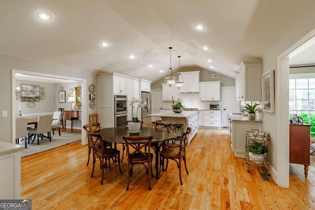 1060 Woodhollow Ln, Athens, GA 30606 - dining room with light wood-style floors, lofted ceiling, recessed lighting, and a chandelier