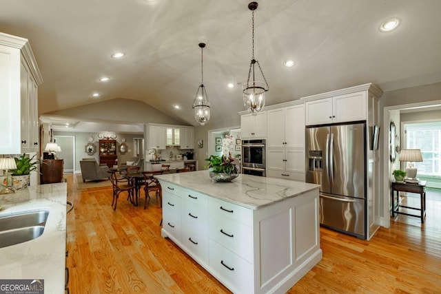 1060 Woodhollow Ln, Athens, GA 30606 - kitchen featuring appliances with stainless steel finishes, white cabinetry, a chandelier, a center island, and vaulted ceiling