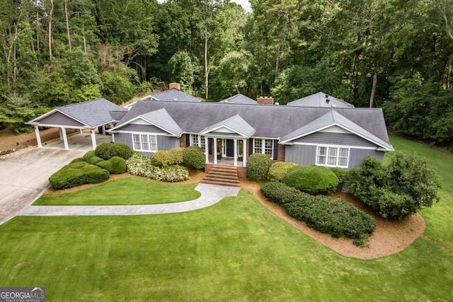 1060 Woodhollow Ln, Athens, GA 30606 - view of front facade featuring a front lawn, concrete driveway, and a chimney