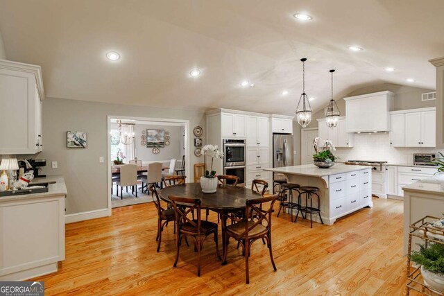 1060 Woodhollow Ln, Athens, GA 30606 - dining space featuring vaulted ceiling, light wood-style floors, and recessed lighting