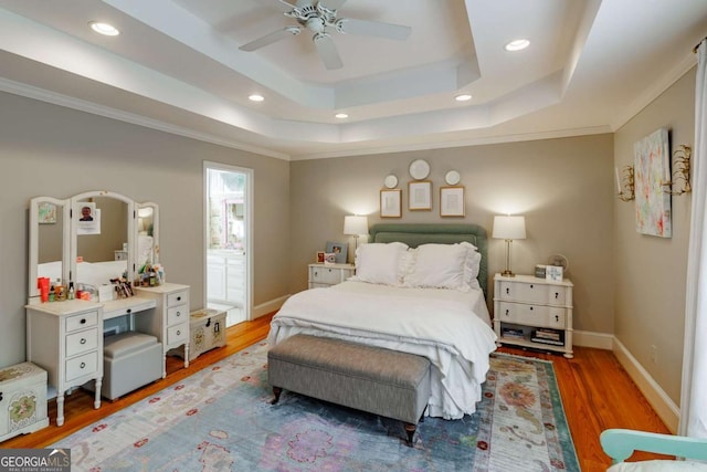 1060 Woodhollow Ln, Athens, GA 30606 - bedroom with wood finished floors, a raised ceiling, recessed lighting, a ceiling fan, and crown molding