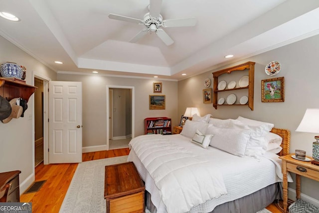 1060 Woodhollow Ln, Athens, GA 30606 - bedroom featuring a tray ceiling, recessed lighting, light wood-type flooring, a ceiling fan, and ornamental molding