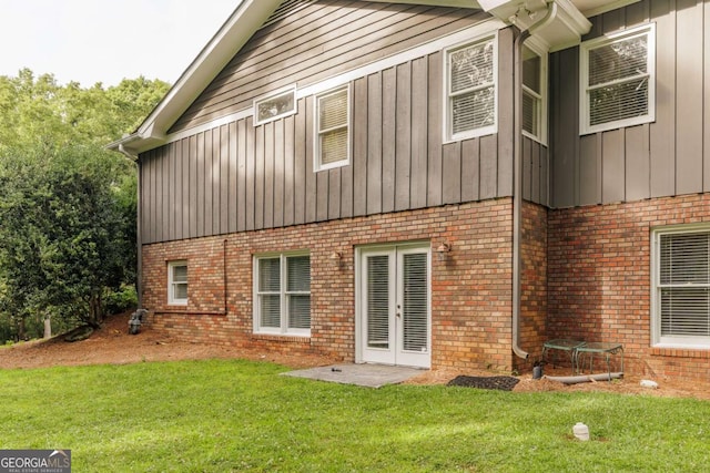 1060 Woodhollow Ln, Athens, GA 30606 - rear view of house featuring brick siding, french doors, a yard, and board and batten siding