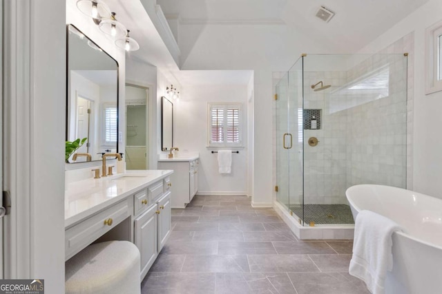 5007 Highland Oaks Ct SE, Smyrna, GA 30126 - bathroom with vanity, a shower stall, plenty of natural light, and a freestanding tub