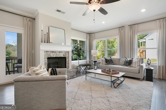 550 Azalea Xing, Dallas, GA 30132 - living room featuring ornamental molding, plenty of natural light, ceiling fan, a stone fireplace, and hardwood / wood-style floors