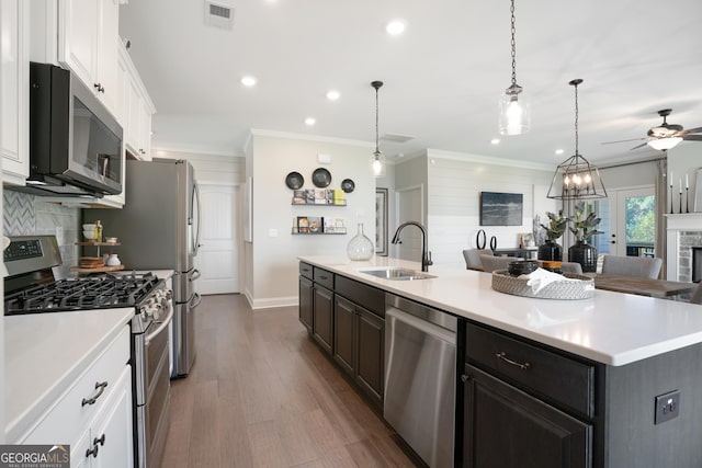 550 Azalea Xing, Dallas, GA 30132 - kitchen with appliances with stainless steel finishes, white cabinets, light countertops, decorative backsplash, and a spacious island