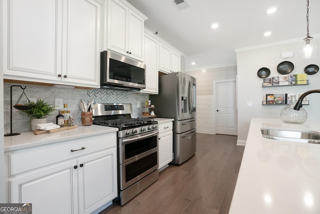 550 Azalea Xing, Dallas, GA 30132 - kitchen with appliances with stainless steel finishes, white cabinetry, light countertops, crown molding, and tasteful backsplash