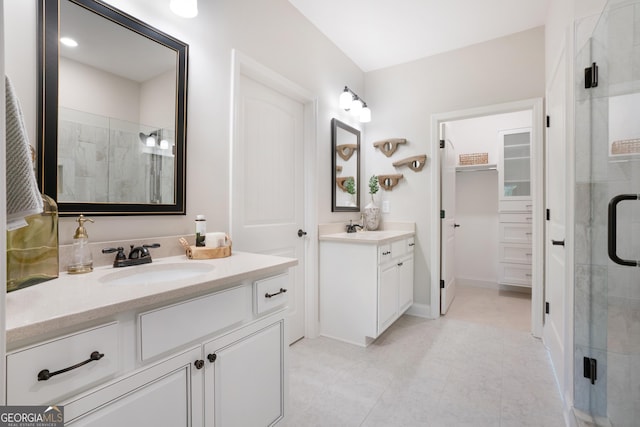 550 Azalea Xing, Dallas, GA 30132 - bathroom featuring a shower stall, two vanities, a spacious closet, and tile patterned floors