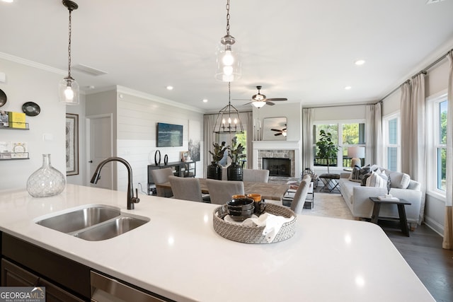550 Azalea Xing, Dallas, GA 30132 - kitchen featuring light countertops, open floor plan, ornamental molding, a ceiling fan, and a fireplace