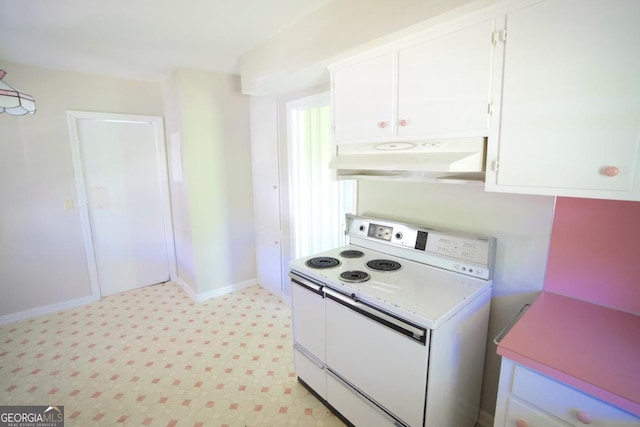 5530 Perry Ave, Columbus, GA 31909 - kitchen with white electric range, under cabinet range hood, white cabinetry, light countertops, and light flooring