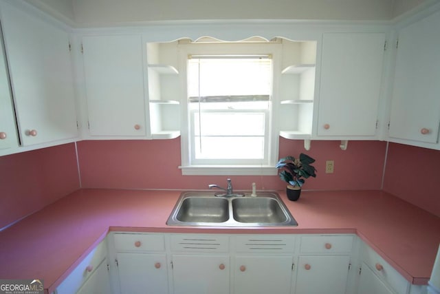 5530 Perry Ave, Columbus, GA 31909 - kitchen featuring open shelves, white cabinets, and light countertops