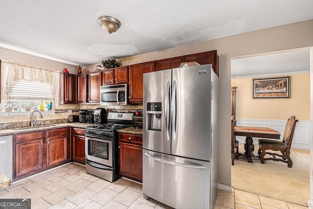 11961 Markham Way, Hampton, GA 30228 - kitchen with appliances with stainless steel finishes, light tile patterned floors, stone counters, decorative backsplash, and a textured ceiling