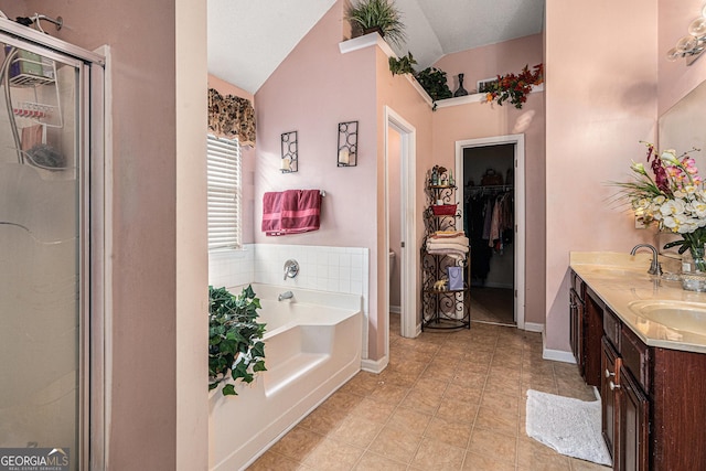 11961 Markham Way, Hampton, GA 30228 - bathroom with a garden tub, lofted ceiling, a shower stall, double vanity, and tile patterned flooring