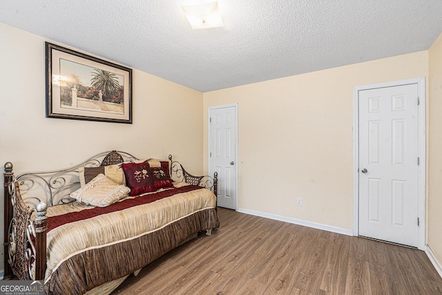 11961 Markham Way, Hampton, GA 30228 - bedroom featuring wood finished floors and a textured ceiling