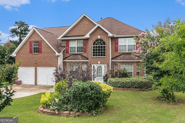 11961 Markham Way, Hampton, GA 30228 - view of front facade with concrete driveway, brick siding, a front yard, and roof with shingles