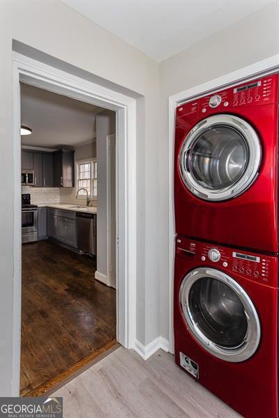 469 Mellview Ave, Atlanta, GA 30310 - laundry area with estacked washer and dryer and dark wood-style flooring