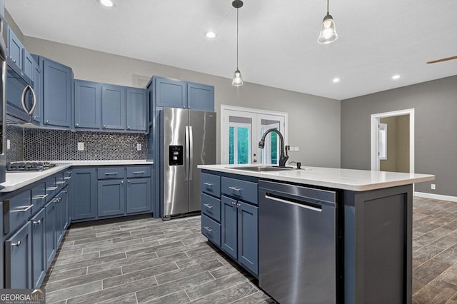 67 Mcnelley Dr, Morganton, GA 30560 - kitchen featuring appliances with stainless steel finishes, blue cabinets, light countertops, tasteful backsplash, and hanging light fixtures
