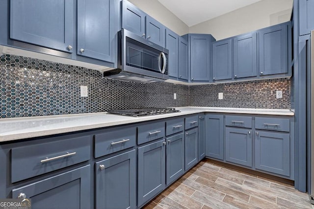 67 Mcnelley Dr, Morganton, GA 30560 - kitchen featuring appliances with stainless steel finishes, light countertops, tasteful backsplash, and light wood-style floors