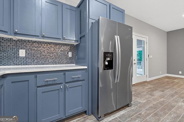 67 Mcnelley Dr, Morganton, GA 30560 - kitchen with stainless steel fridge with ice dispenser, tasteful backsplash, blue cabinetry, and light countertops