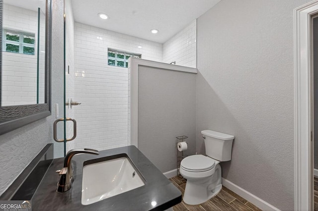 67 Mcnelley Dr, Morganton, GA 30560 - bathroom with wood tiled floors, healthy amount of natural light, a shower with shower door, vanity, and recessed lighting