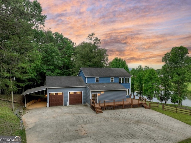 67 Mcnelley Dr, Morganton, GA 30560 - view of front of home featuring concrete driveway, a wooden deck, an attached garage, and view of wooded area
