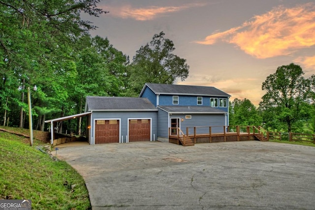 67 Mcnelley Dr, Morganton, GA 30560 - view of front facade with driveway, a wooden deck, an attached garage, and view of wooded area