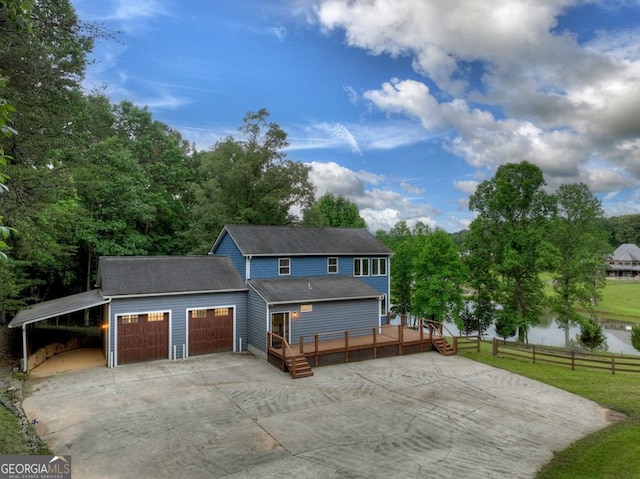 67 Mcnelley Dr, Morganton, GA 30560 - view of front facade with driveway, a wooden deck, a garage, and view of scattered trees