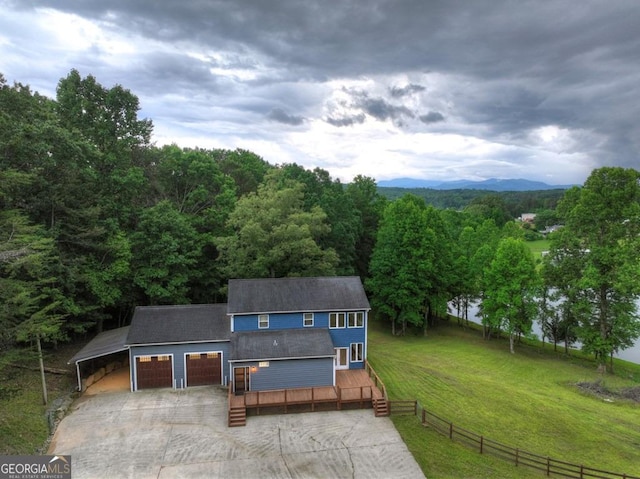 67 Mcnelley Dr, Morganton, GA 30560 - view of front of house with concrete driveway, a deck, a wooded view, and a shingled roof