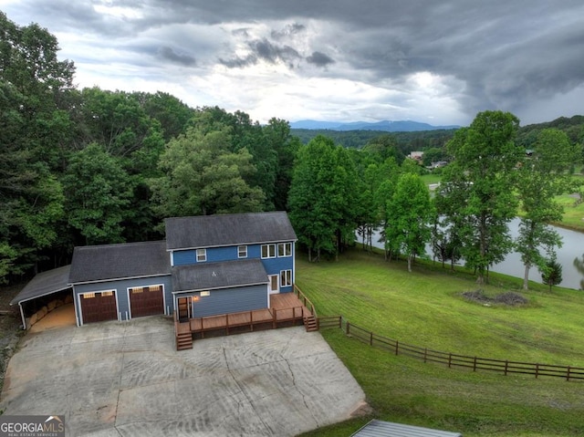 67 Mcnelley Dr, Morganton, GA 30560 - view of front of house featuring concrete driveway, a shingled roof, a forest view, and a deck with water view