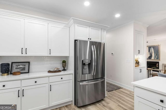 5560 Pilgrim Point Ext, Cumming, GA 30041 - kitchen with stainless steel refrigerator with ice dispenser, white cabinetry, light countertops, tasteful backsplash, and light wood-type flooring