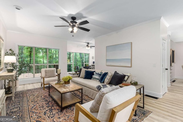 5560 Pilgrim Point Ext, Cumming, GA 30041 - living area with light wood finished floors, crown molding, and ceiling fan