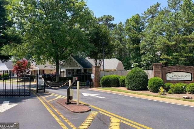 5069 Kathryn Glen Dr, Acworth, GA 30101 - view of asphalt street featuring a gate, street lights, a gated entry, and curbs