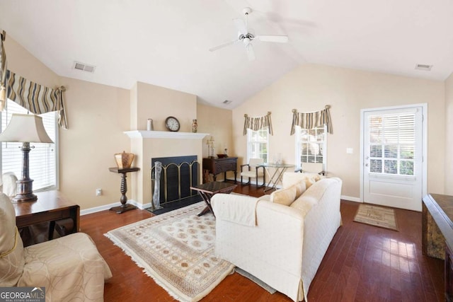 5069 Kathryn Glen Dr, Acworth, GA 30101 - living area featuring vaulted ceiling, a ceiling fan, wood finished floors, and a fireplace with flush hearth