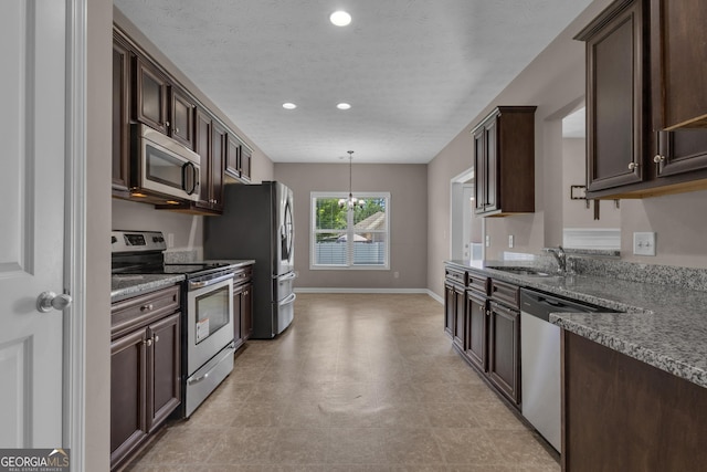 502 Creekside Dr, Lagrange, GA 30240 - kitchen with appliances with stainless steel finishes, dark brown cabinetry, a chandelier, and recessed lighting