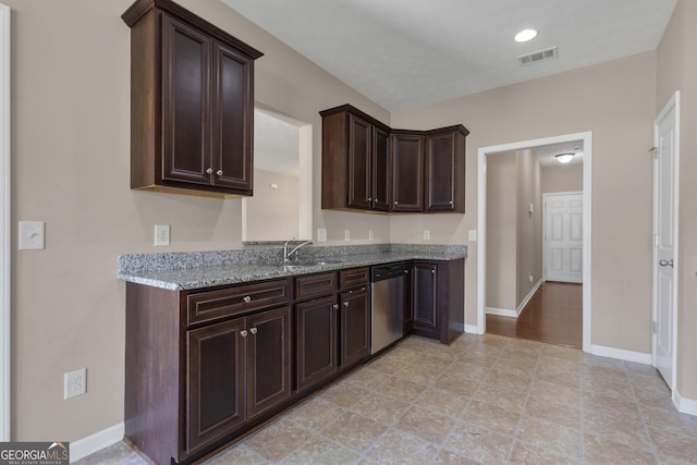 502 Creekside Dr, Lagrange, GA 30240 - kitchen featuring stainless steel dishwasher, dark brown cabinets, and light stone countertops