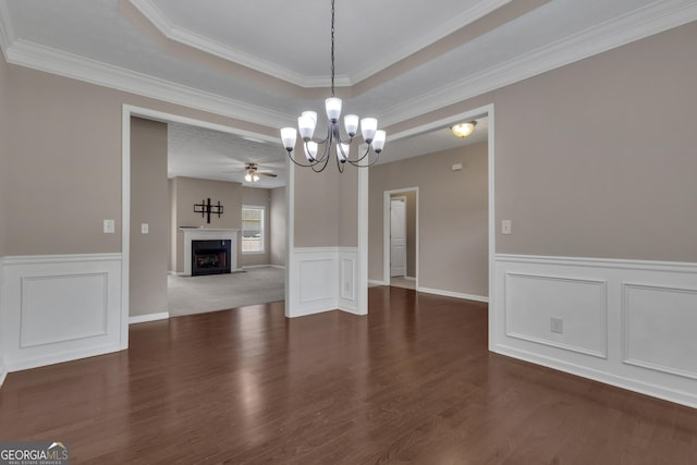 502 Creekside Dr, Lagrange, GA 30240 - unfurnished dining area featuring a chandelier, a fireplace, wood finished floors, a ceiling fan, and wainscoting