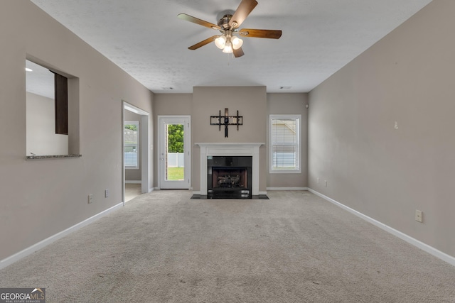 502 Creekside Dr, Lagrange, GA 30240 - unfurnished living room featuring ceiling fan, plenty of natural light, carpet flooring, and a fireplace with flush hearth