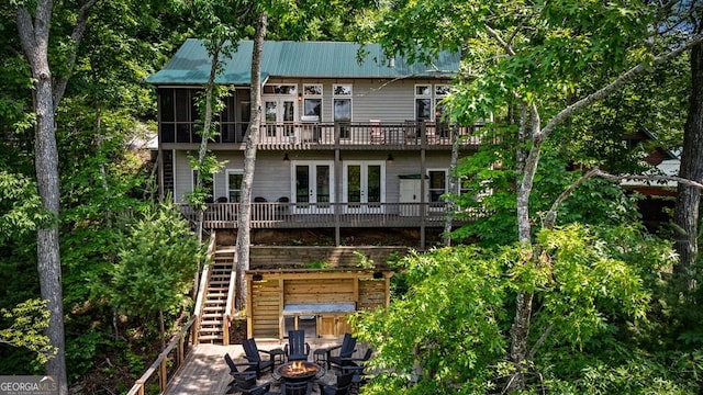 128 Overlake Ct, Morganton, GA 30560 - rear view of property featuring a fire pit, stairway, a metal roof, french doors, and a deck
