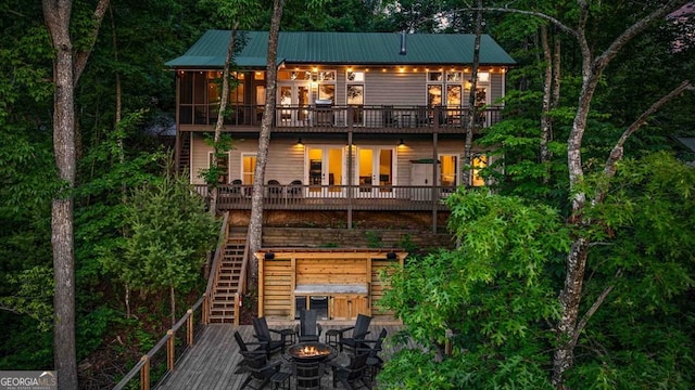 128 Overlake Ct, Morganton, GA 30560 - back of house featuring a fire pit, stairway, a wooden deck, and a metal roof